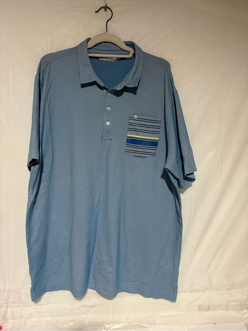 Travis Mathew Light Blue Polo with Striped Chest Pocket